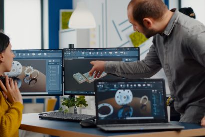 Industrial development engineer sharing ideas with project manager Industrial development engineer analysing and sharing ideas with project manager working on computer. Team of professionals using CAD Software for modern industrial engineering design.